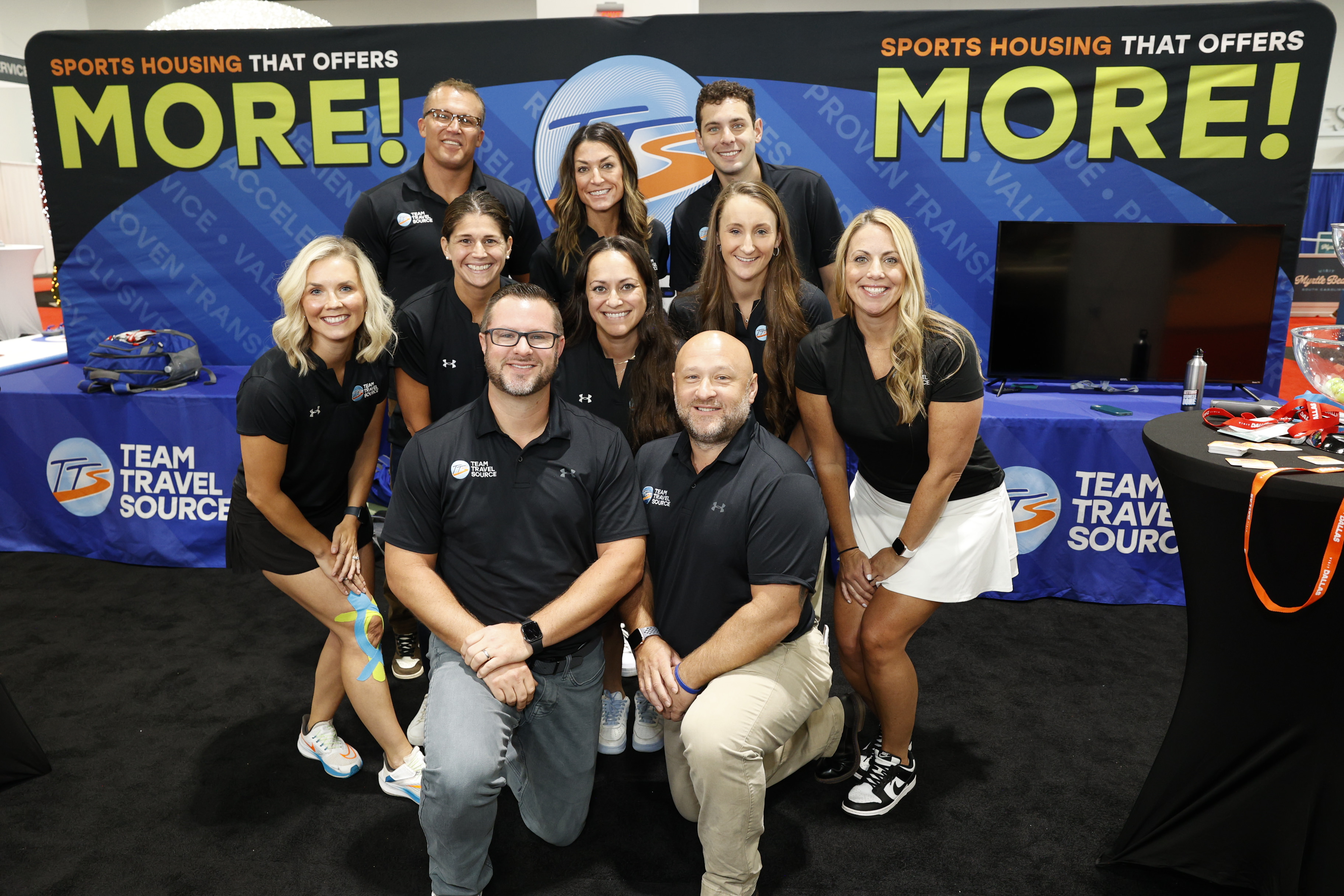Team Travel Source smiling in front of their trade show booth at Connect Marketplace.