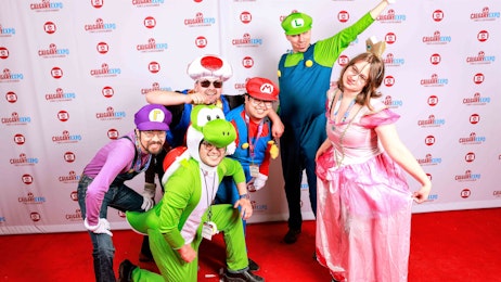 A group of Super Mario cosplayers smile on the red carpet