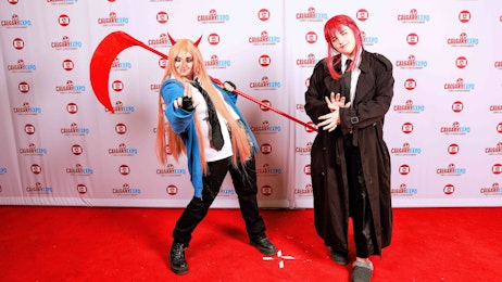 Two demon slayer cosplayers pose on the red carpet