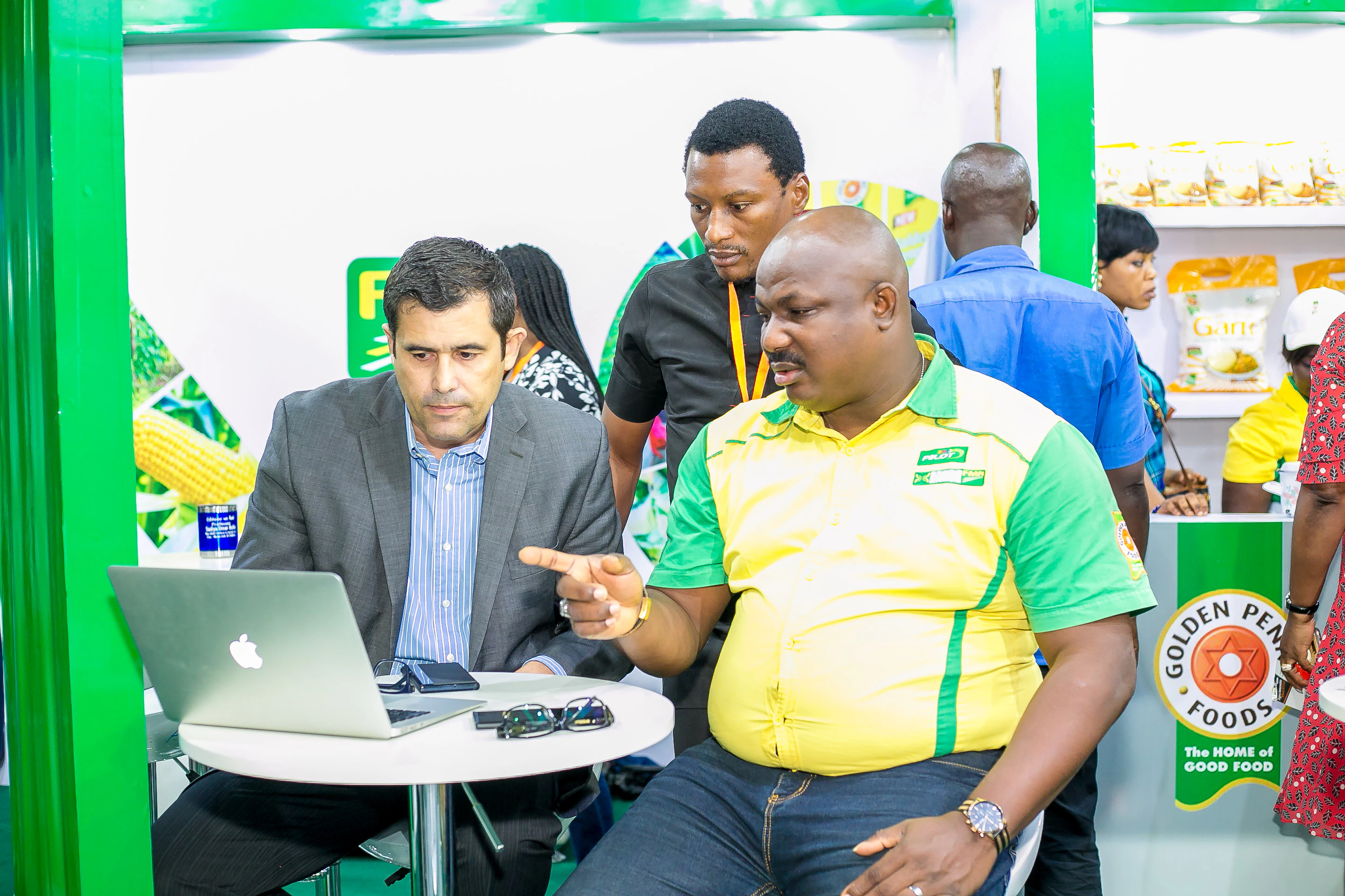 Agriculture professionals discussing digital farming solutions and agritech innovations at Growtech West Africa exhibition.