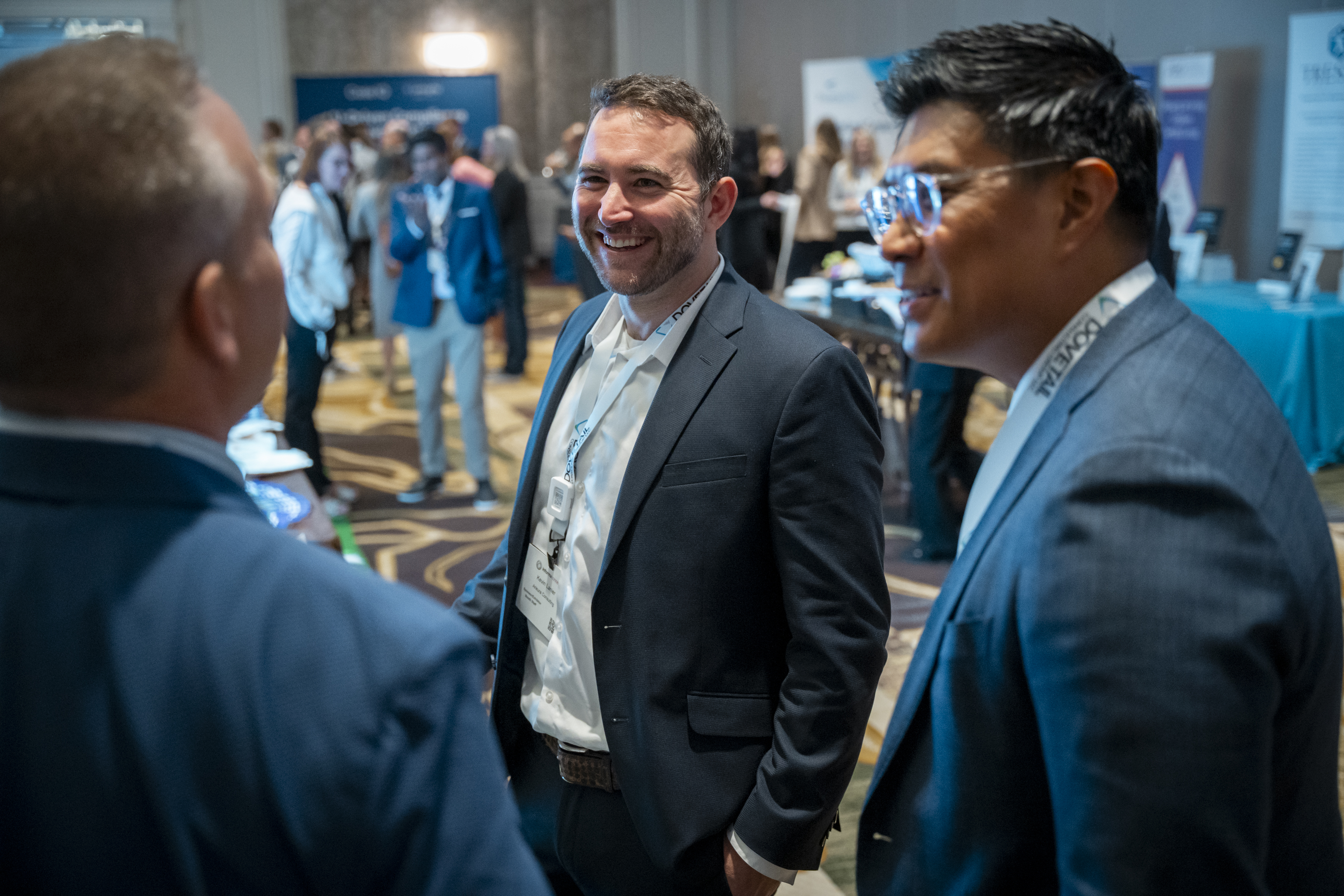 Three men laugh whilst in discussion at Transparency & HCP Engagement.