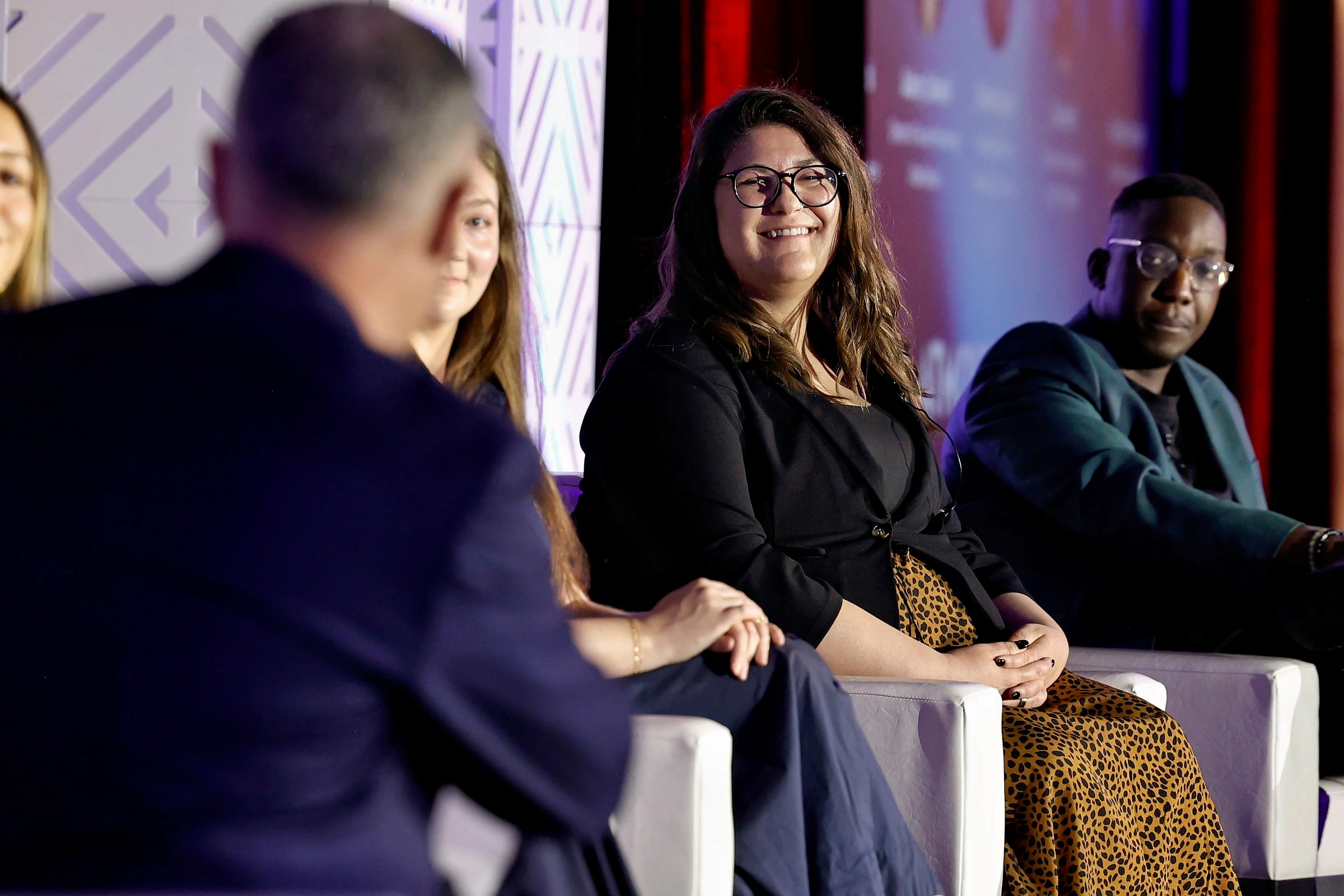 Two women on stage at eTourism Summit smiling and holding their eTSY Award.