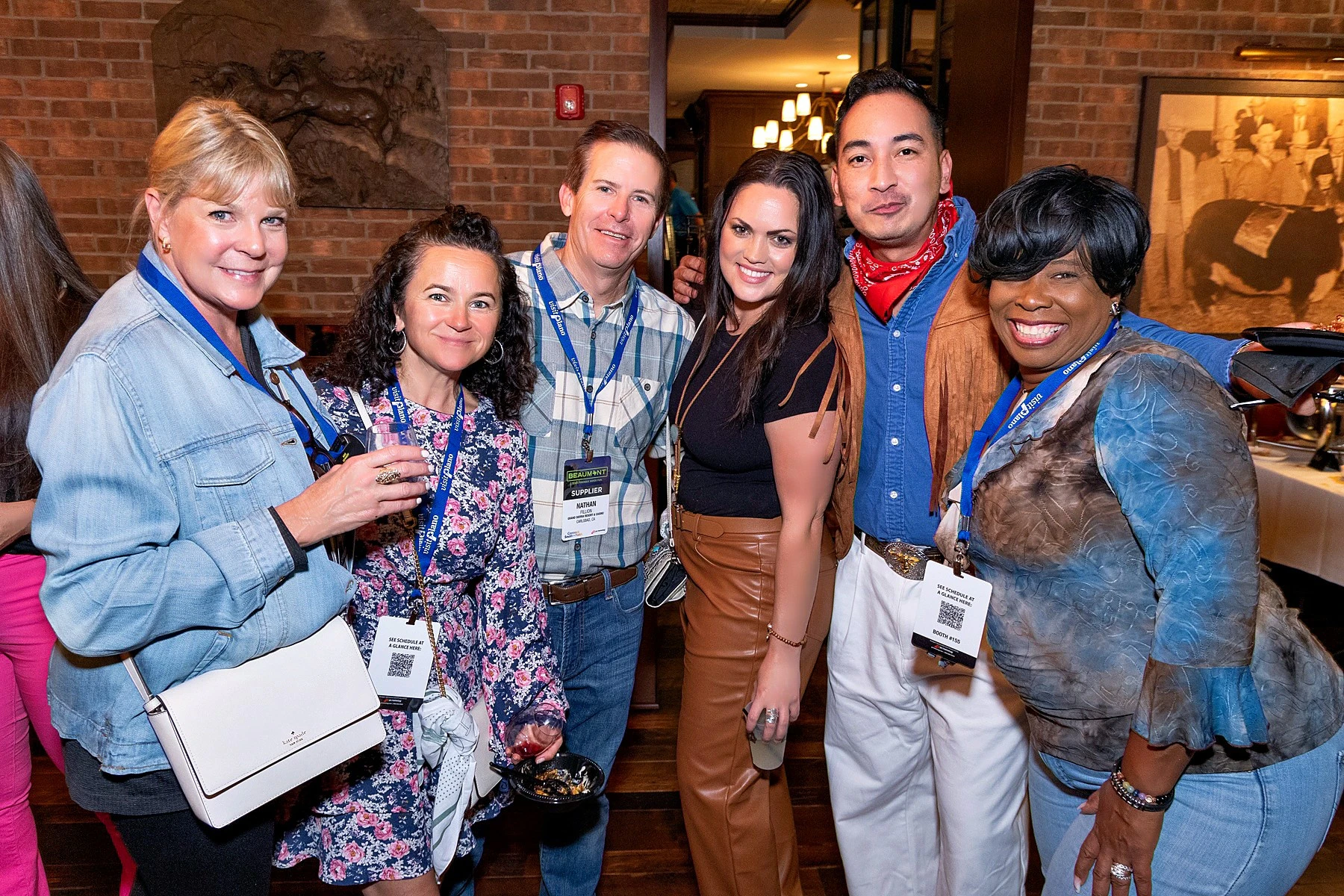 A group of event professionals smiling together before heading to marketplace appointments.