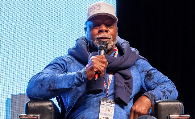 carl weathers onstage holding microphone