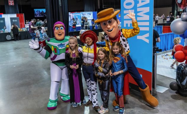 toy story cosplayers hug kids near a sign that says Family Zone