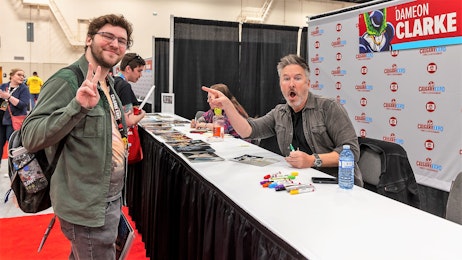Dameon Clarke smiles with a fan at his table
