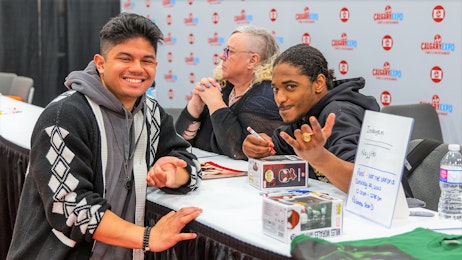 Nadji Jeter smiles with a fan at his booth