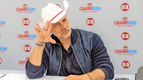 Todd Stashwick poses in a cowboy hat at his table