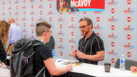 James McAvoy is talking with a fan at his table