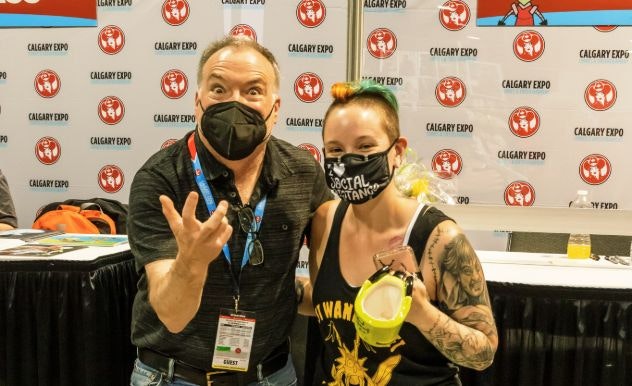 Richard Horvitz poses with a fan for a photograph