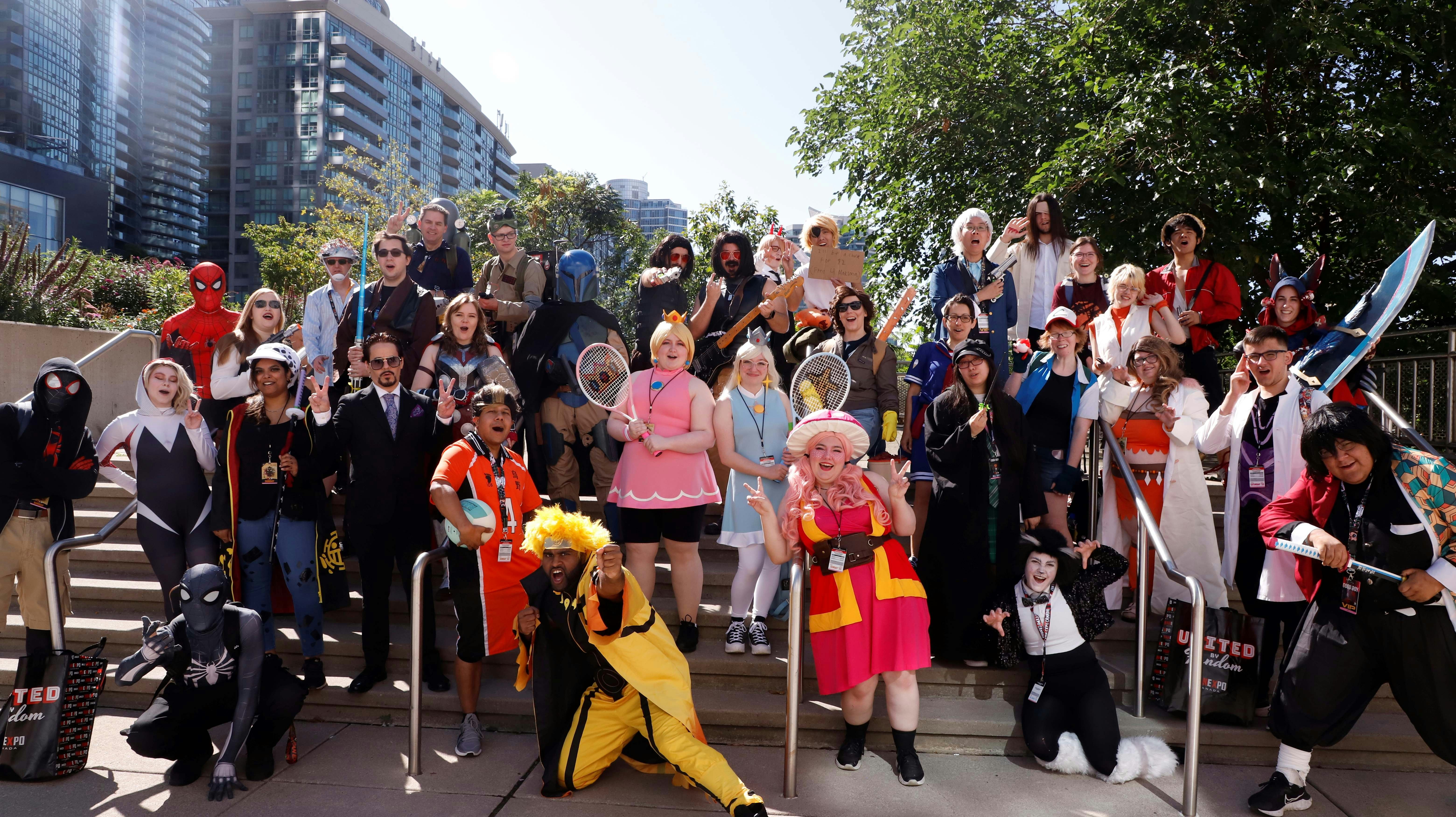 FANS POSE IN COSPLAY ON THE STEPS OUTSIDE OF THE CONVENTION CENTRE