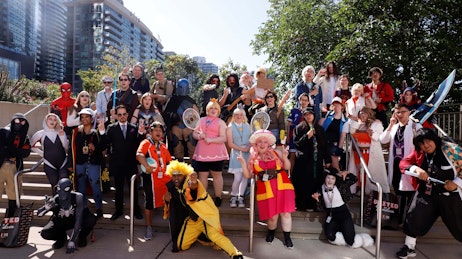 Group of cosplayers posing on the steps