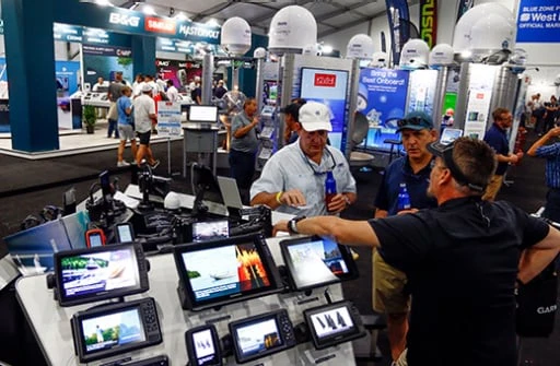 Exhibitor booths featuring marine technology at Fort Lauderdale Boat Show