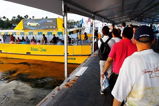 Boat show attendees enjoying waterfront exhibits at FLIBS