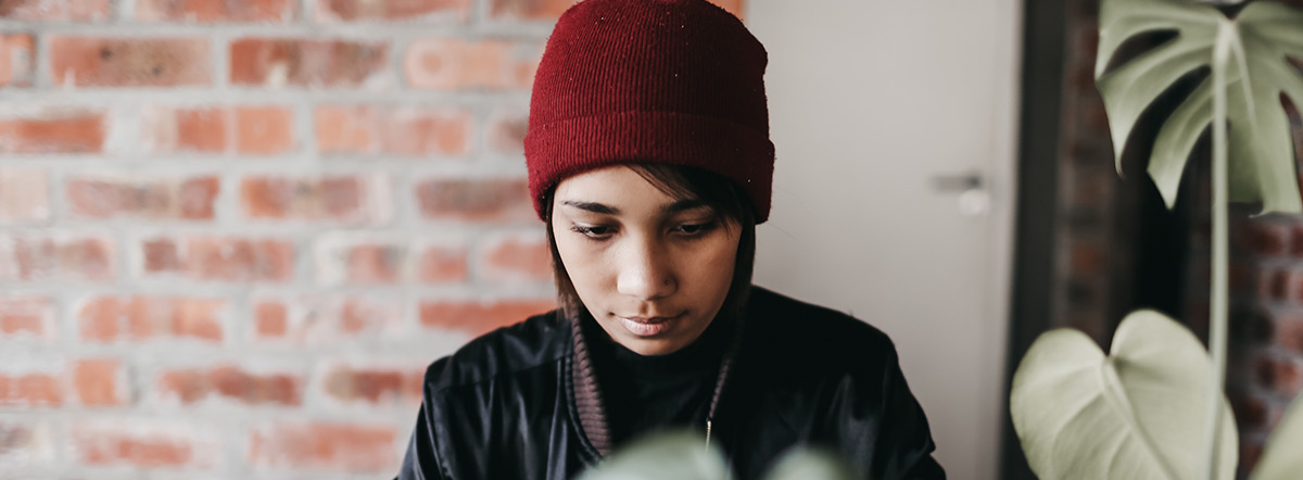 CodeSpace young woman looking  at laptop while coding