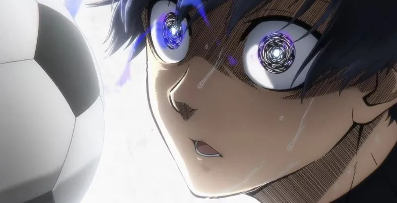 A screen cap from Blue Lock, with protagonist Yoichi Isagi laser-focused in the midst of a soccer match.