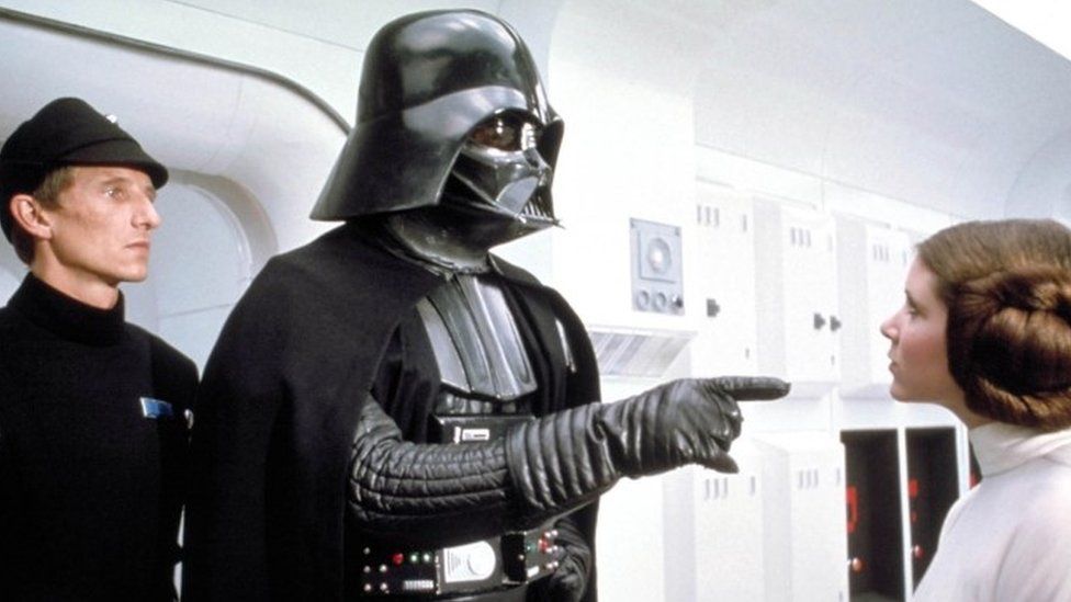 Darth Vader from Star Wars pointing at Princess Leia