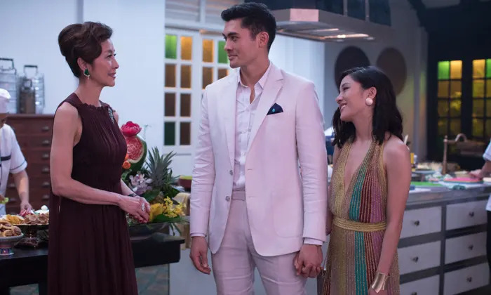 Left to right: Eleanor Sung-Young (Michelle Yeoh) speaking to her son, Nick Young (Henry Golding), and his girlfriend, Rachel Chu (Constance Wu).