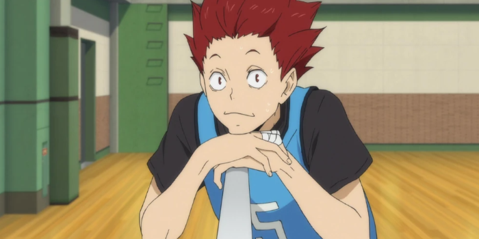 Young athlete looking expectantly at someone in a school gym