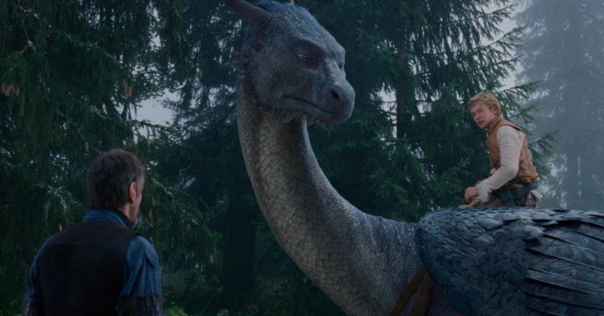 A shot from the movie, featuring Eragon (Ed Speelers) sitting on the back of Sephira (Rachel Weisz), all while Brom (Jeremy Irons) looks on at them.