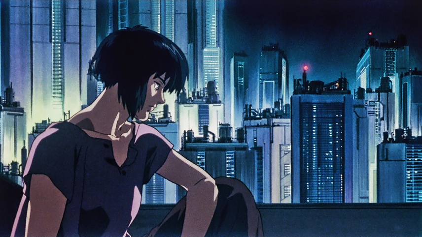 The protagonist of Ghost in the Shell, the Major (Motoko Kusanagi), sitting on a roof in civilian clothes. Behind her are the many skyscrapers that make up Niihama (AKA New Port City).