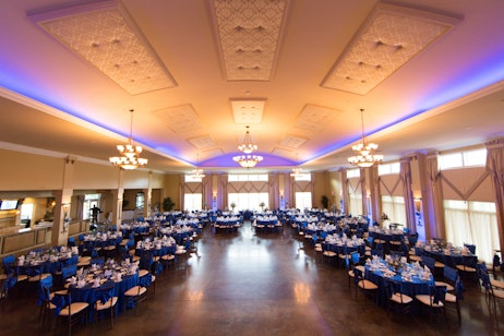 indoor venue with blue tables setup