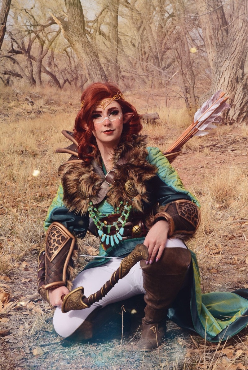 CheesecakePanda posing in a red wig and furry necklace