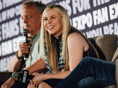 Dee Bradley Baker (left) holding a microphone, and Ashley Eckstein (right) smiling and laughing.