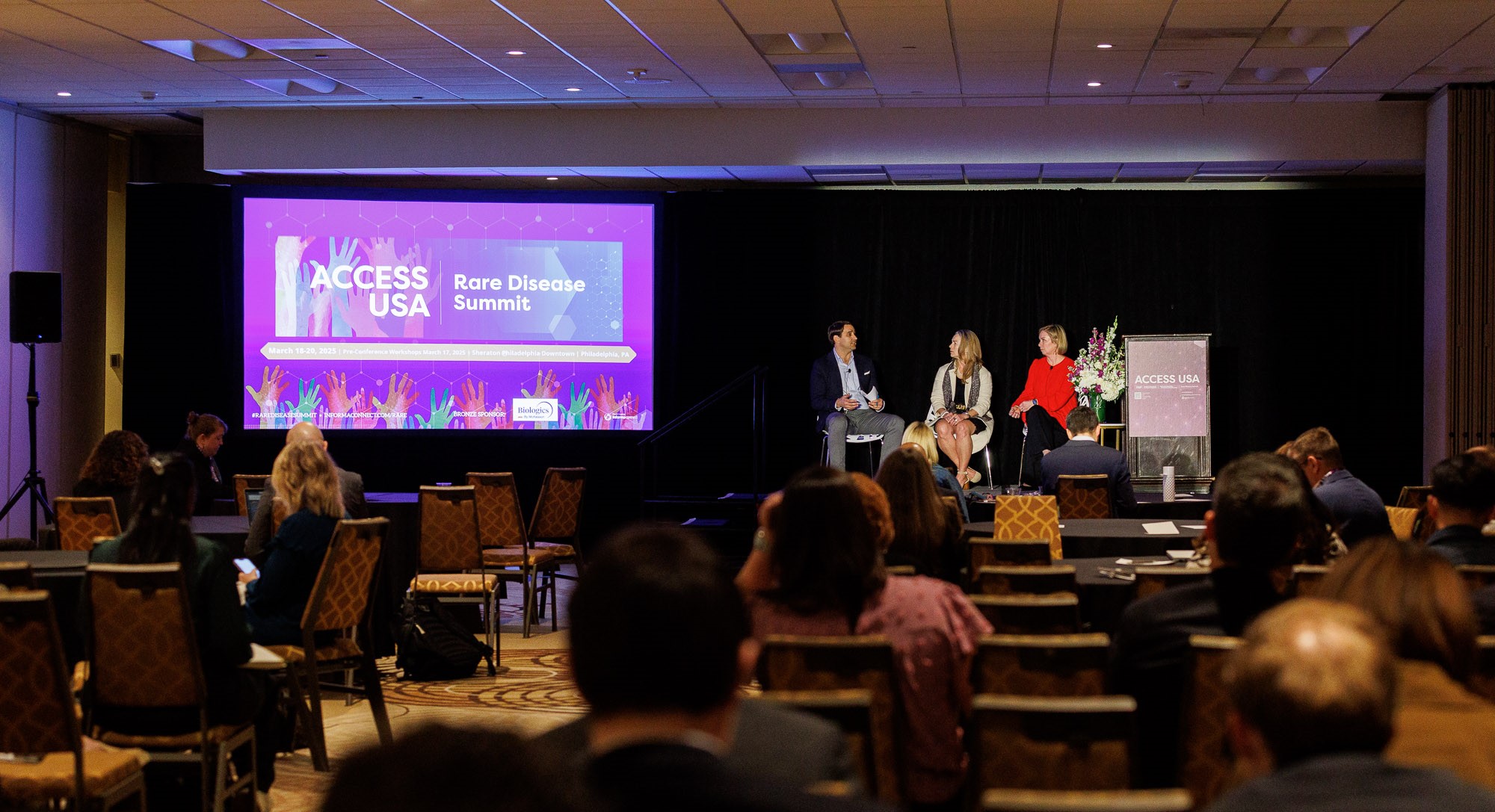 Panellists speak on stage at Rare Disease Summit part of Access USA