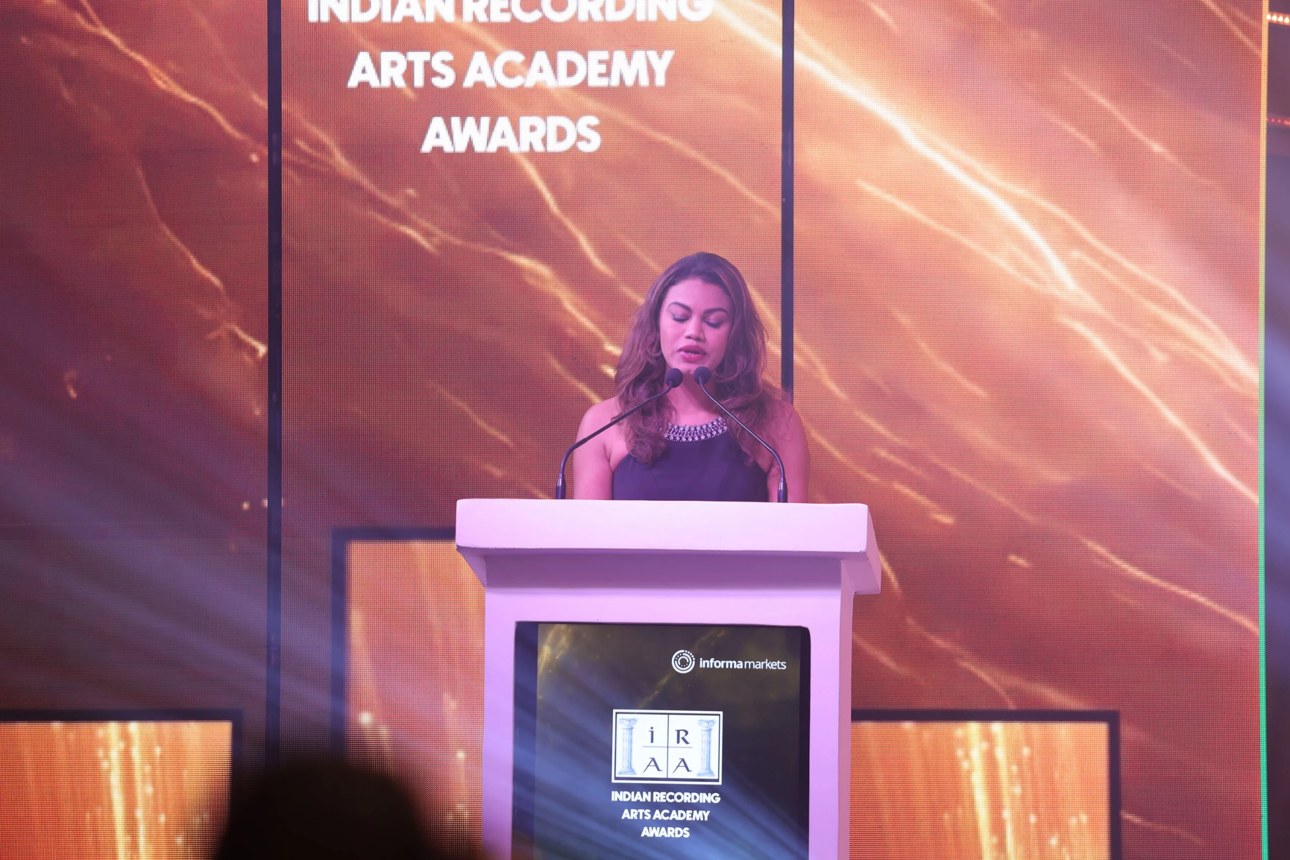 Emcee Aradhana Nayar welcomes and addresses the audience.