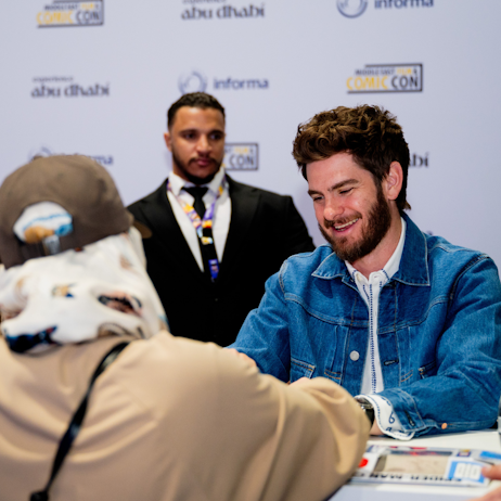 Celebrity guest signing with a fan at MEFCC 2025
