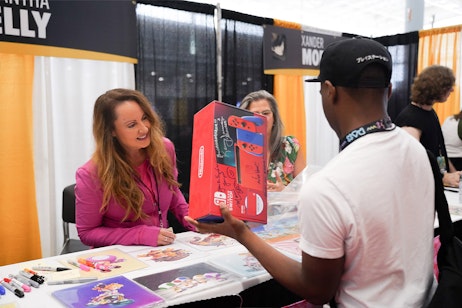 Samantha Kelly smiles after signing a Switch box