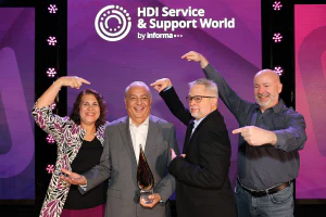 Team members celebrate a colleague receiving recognition during the HDI Global Service & Support Awards Ceremony.