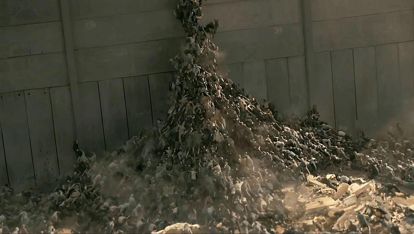 A mountain of zombies begins to form in an effort to scale the wall of a large building.