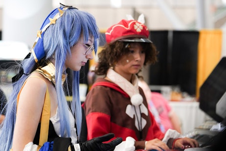 Two fans playing an arcade game