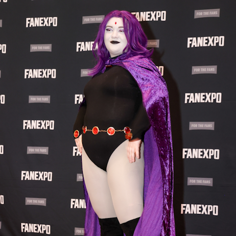 Teen Titan cosplayer poses on red carpet dressed as Raven