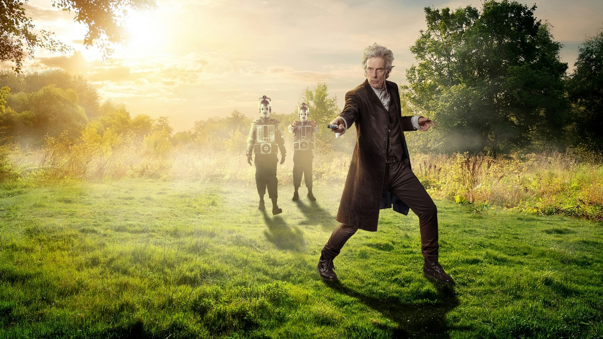 The Doctor, in a field, is being followed by two Cybermen. Pointing the sonic screwdriver at more Cybermen in the distance.