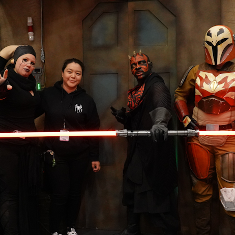 Twi'lek, a fan, Darth Maul and a Mandalorian pose for a picture