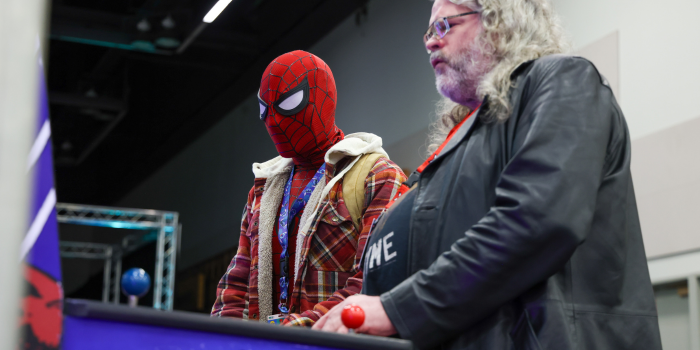 GAME ON! SPIDER-MAN, DRESSED FOR THE CRISP PORTLAND WEATHER, TAKES ON AN OPPONENT IN OUR RETRO ARCADE (GAME NOT VISIBLE)