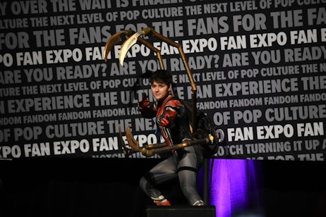 A cosplayer, dressed as the Iron Spider hits the Spider-Man pose on the stage at the Masters of Cosplay grand prix