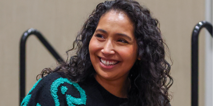 Kathleen Herles, listening intently to the moderator, smiles a beautiful full smile during her FAN EXPO Portland panel