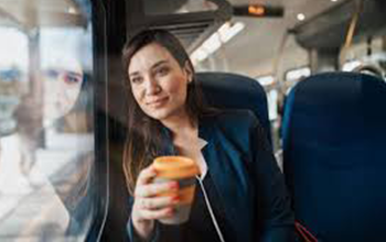 a photo of a woman with coffee on train commute