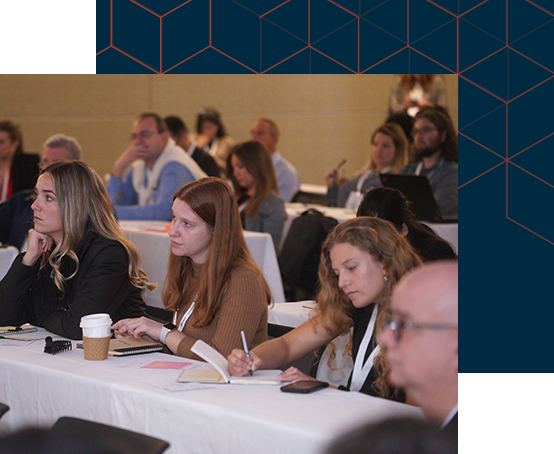 Attendees seated at tables in a conference room