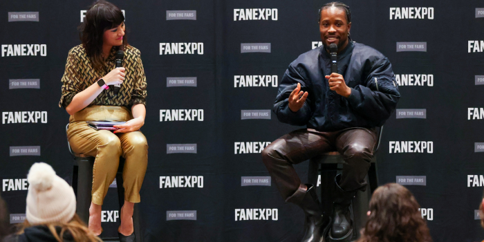 Shameik Moore (right) speaks with great passion using his hands while the audience and moderator look on.