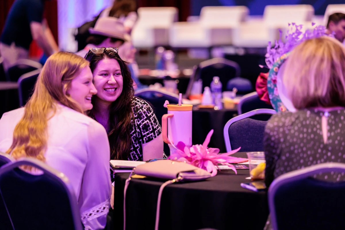 Two men and one woman sitting on stage at eToursim Summit having a panel discussion.