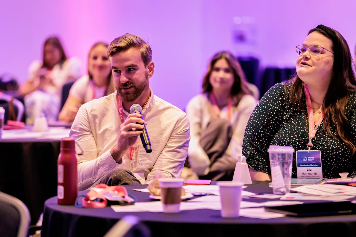Two men on stage at eToursim Summit leading a session.