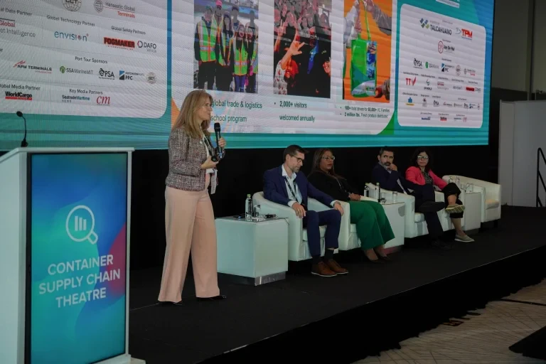 Speaker presenting onstage during a TOC conference session.