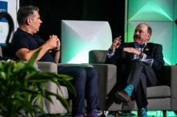 Micheal Hoffman speaking to a speaker at the Investor Summit