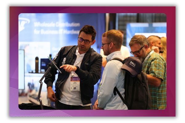 A photo of two men talking on a busy trade show floor
