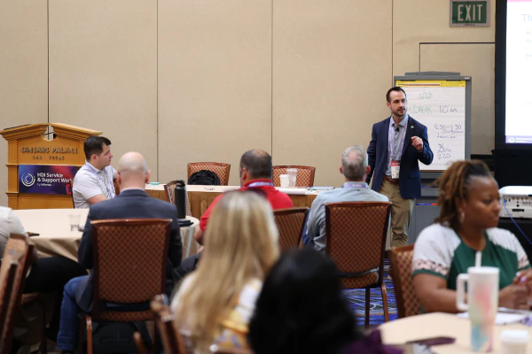 Speaker presenting to a full room of attendees at an HDI Service & Support World workshop.